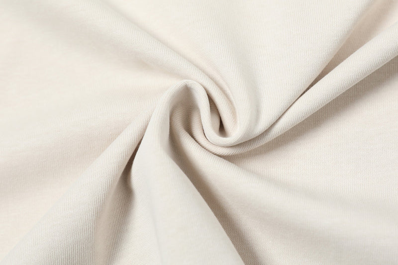Cream oversized washed T-shirt fabric with soft knit texture and draped streetwear styling