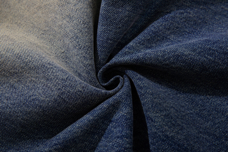 Close-up of denim fabric texture in dark and light faded washes