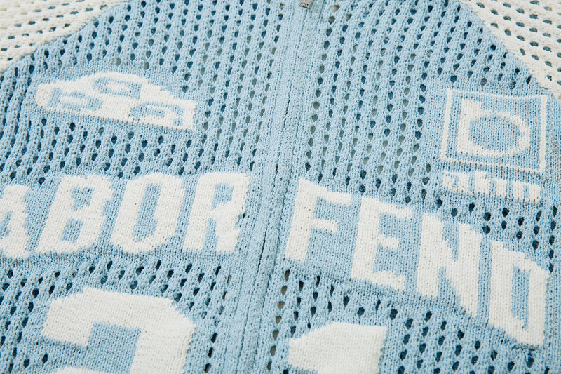 Close-up of light blue back lettering and small logo patch on mesh knit jacket