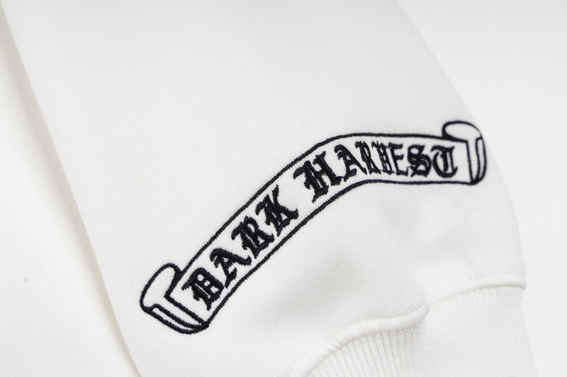 Close-up of sleeve print showing Dark Harvest banner text on white fabric