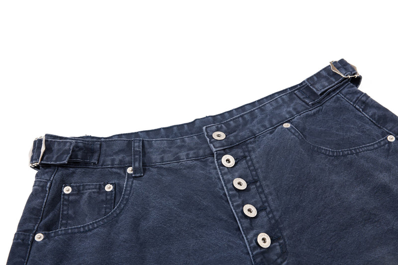 Close-up of dark wash denim shorts back waist and side pocket detail