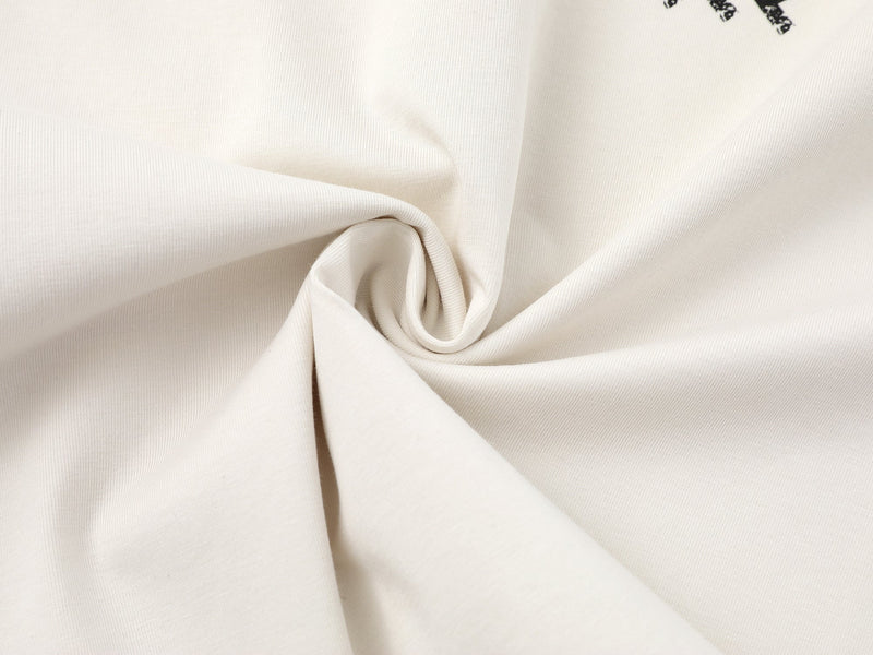 Close-up of cream tee fabric texture gathered into a swirl