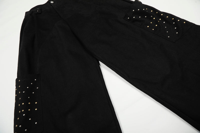Black cargo pants leg with studded pocket detail, angled view