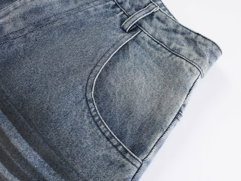 Close-up of the side pocket and curved seam on blue washed denim