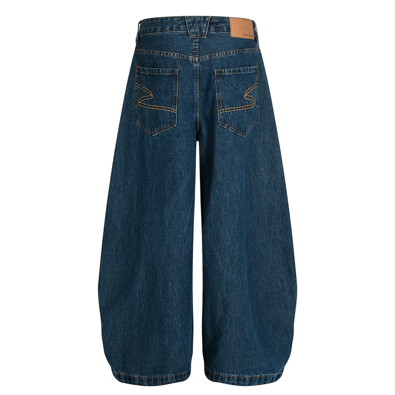 Back view of deep indigo wide-leg jeans with patch pockets and tan paper label