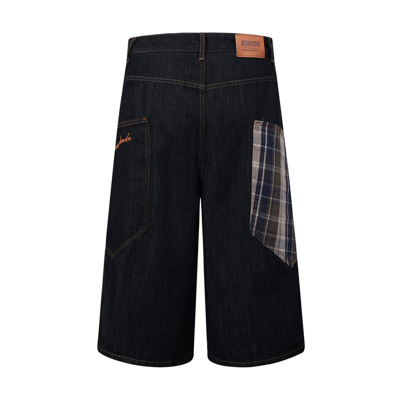 Back view of dark indigo denim jorts with leather logo patch and plaid side insert