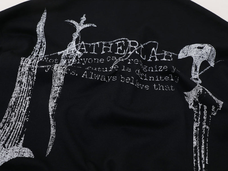 Close-up of back graphic print on black long sleeve polo with distressed white lettering