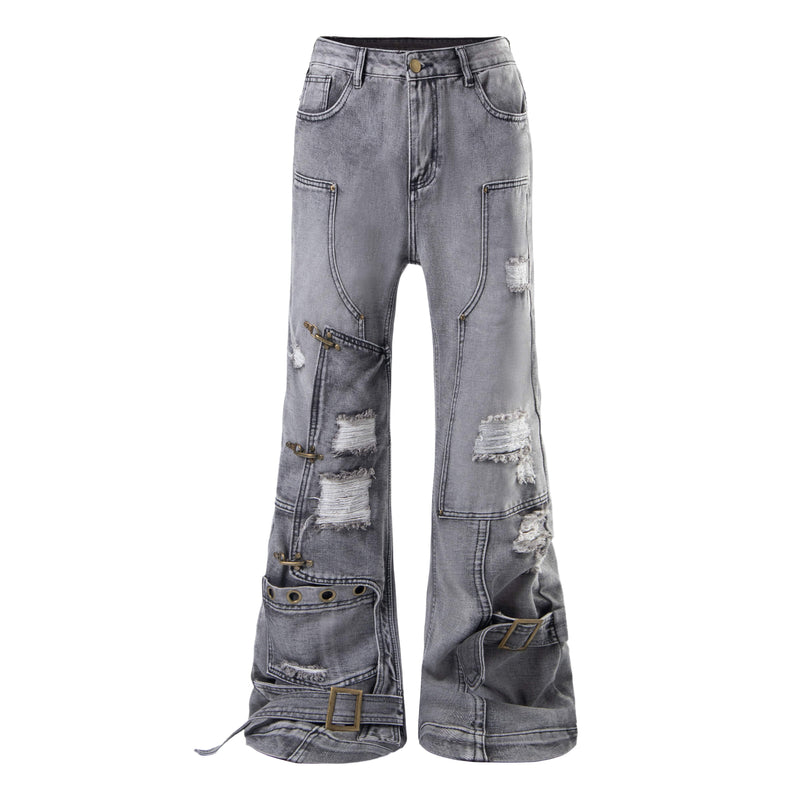 Front view of grey wash distressed flare jeans with patchwork seams, grommets, and rip details