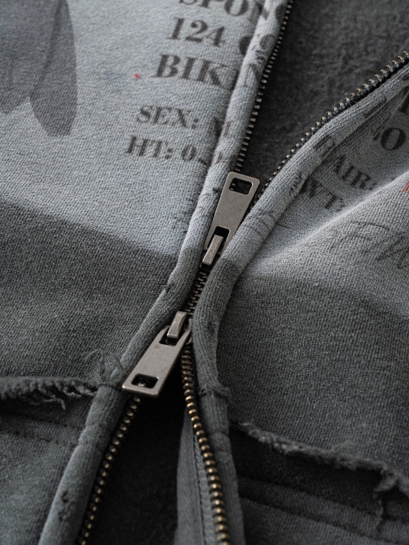 Close-up of gray hoodie front zipper and printed interior graphic text