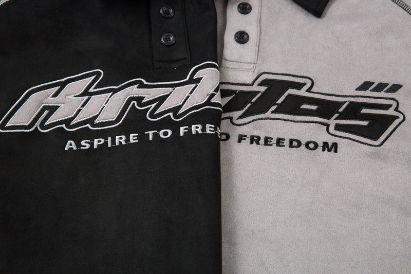 Side-by-side close-up of black and light gray polo shirt front graphics