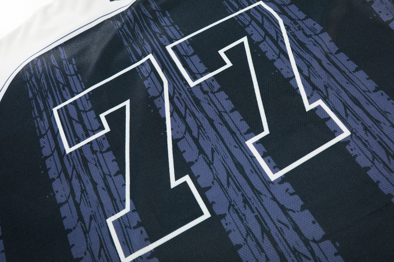 Black mesh soccer jersey with large white 77 graphic and purple distressed streak print on the chest