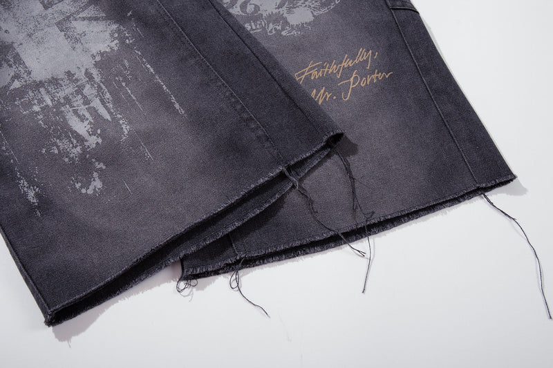 Close-up of hem and graphic print on dark denim wide-leg shorts