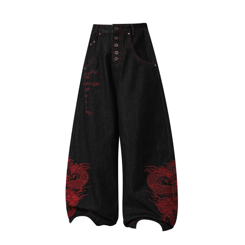 Front view of black wide-leg denim pants with red dragon embroidery and script detail