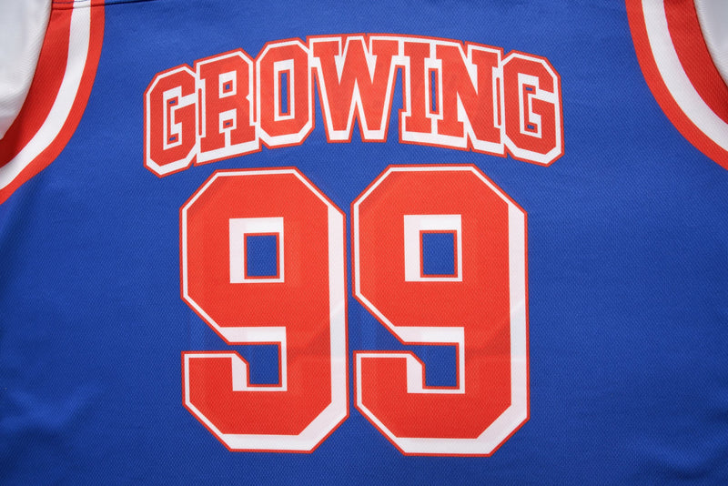 Blue varsity mesh crop jersey with red and white trim, featuring Growing 99 graphic on the front