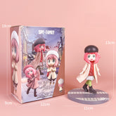 The Spy × Family Detective Anya PVC Figure Set, 14 cm tall with 4 poses, is showcased against a pink background. It highlights movie version features like her pink hair, black hat, and beige coat atop a round base. Dimensions for both the box and figurine are clearly marked for collectors.