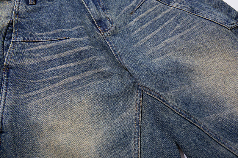 Close-up of front thigh and pocket details on faded blue wide-leg denim