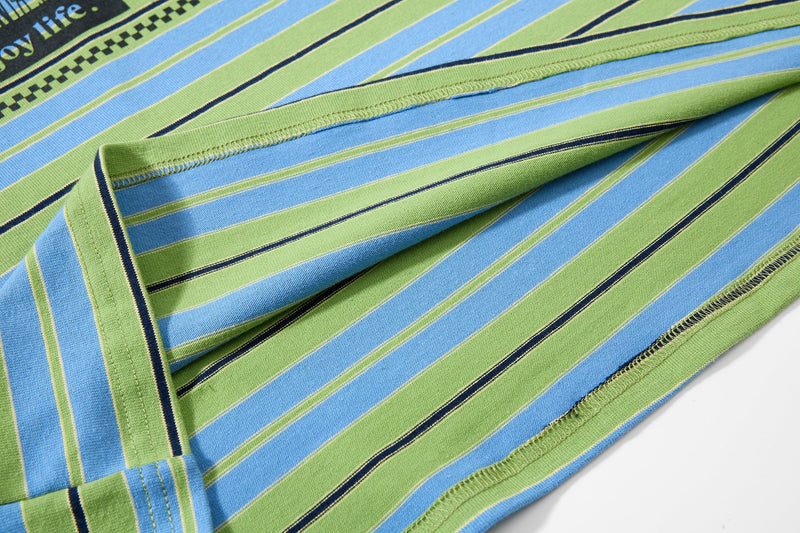Close-up of striped cuff and stitched sleeve seam over white long sleeve