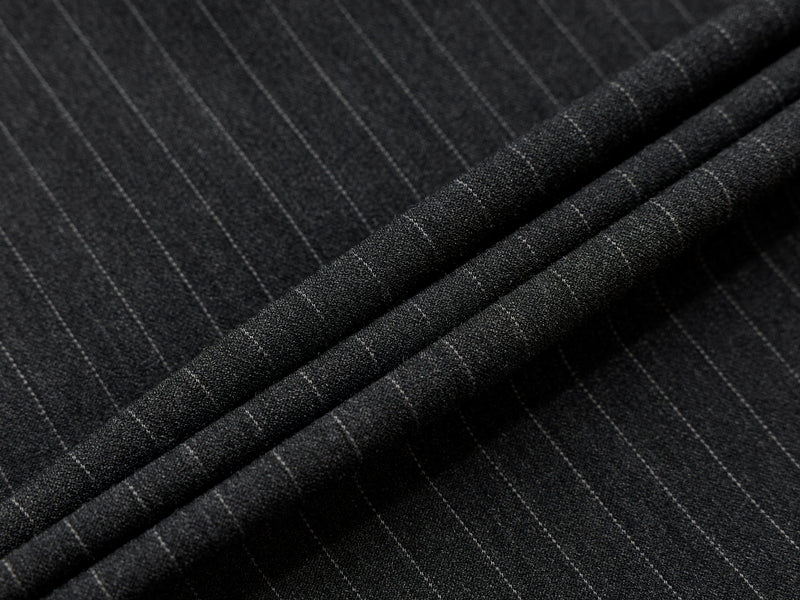 Macro close-up of charcoal pinstripe fabric with layered folds
