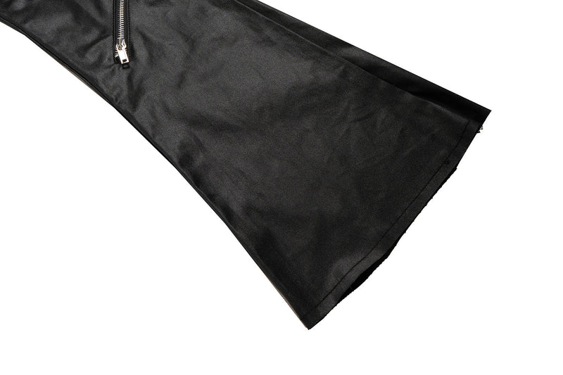 Side hem close-up of black leather-effect flare pants with zipper detail