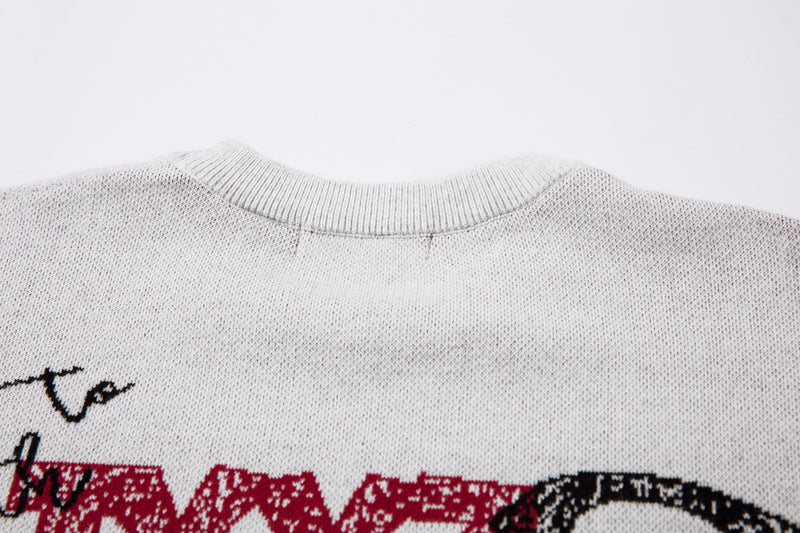 Close-up of white knit sweater collar and textured knit fabric