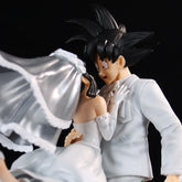 The Seakoff Goku and Chi-Chi Wedding Collectible Figure (Dragon Ball Z, 31cm) perfectly captures the essence of fan collectibles with Chi-Chi in a white gown and veil and Goku in a white tuxedo with spiky black hair, embracing joyfully against a dark background.