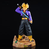 The Seakoff Trunks Collectible Figure from Dragon Ball Z, standing 50cm tall, features spiky yellow hair on an interchangeable head. He wears a purple jacket, black pants, and a blue sash while holding a sword over his shoulder. The base is embossed with "Dragon Ball Z," capturing the anime&