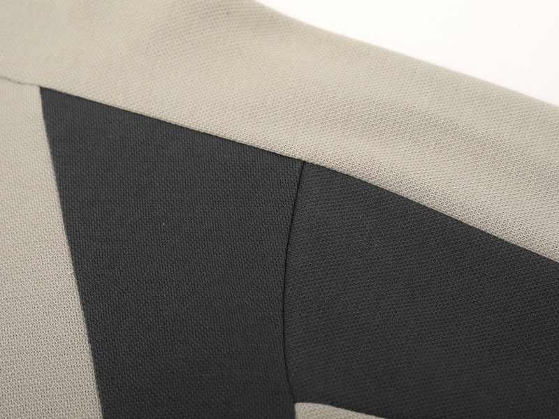 Close-up of side contrast panel and seam on beige sweatshirt