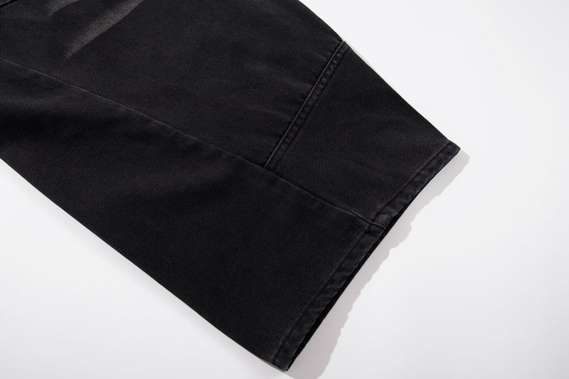 Close-up of dark denim hem with wide-leg cuff stitching