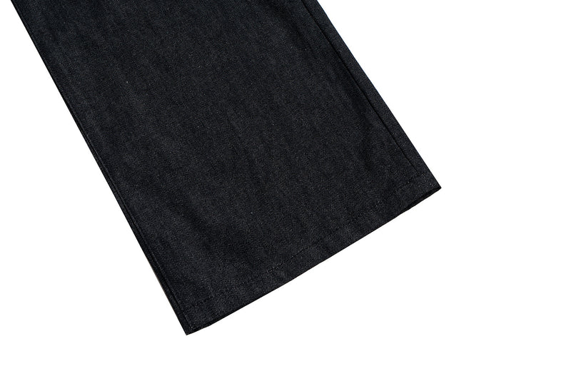 Close-up of the hem on black denim jeans