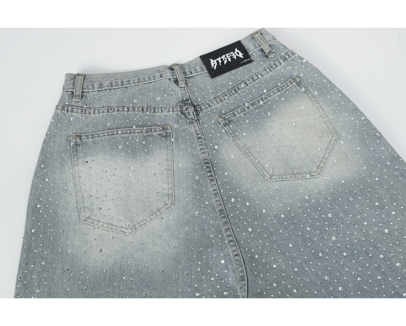 Back waist of light-wash jeans with rhinestone embellishment and patched back pockets