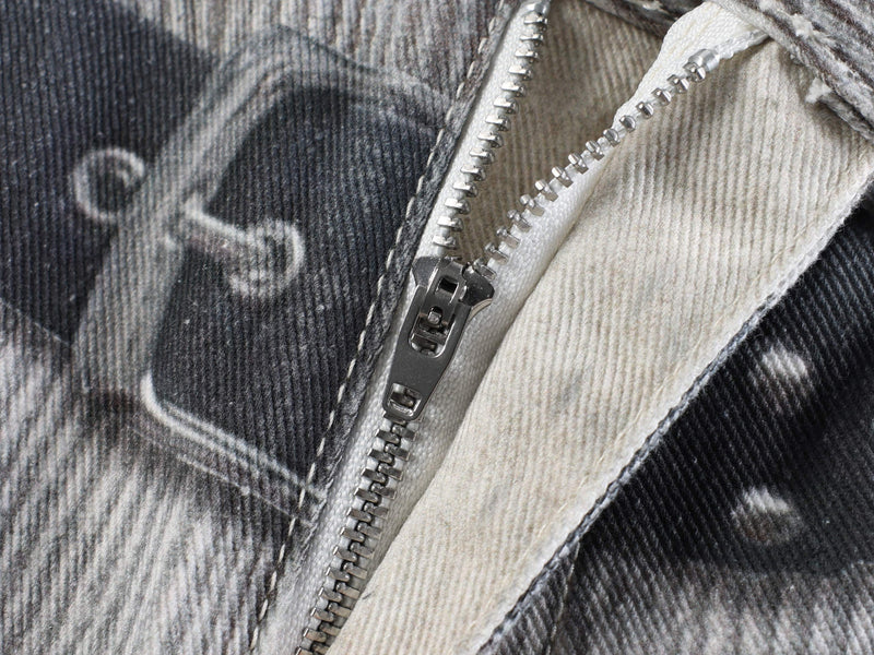 Close-up of side zipper detail on black and cream printed denim panel