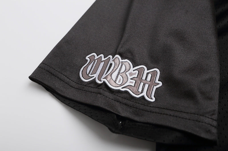 Black mesh football jersey hem with gothic embroidered Seakoff logo on a streetwear shirt