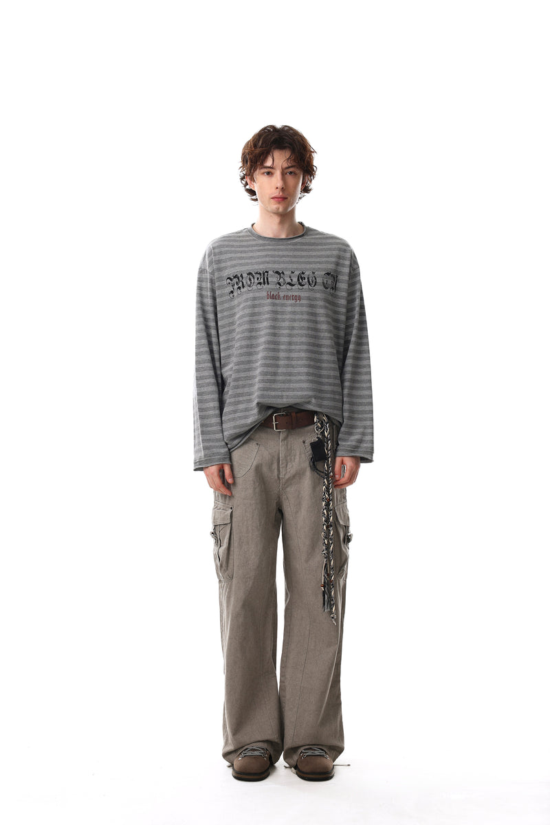 Full-body model view of gray striped long sleeve tee with Gothic chest graphic and loose fit