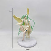 The Hatsune Miku Light & Dark 17cm PVC Figure features green hair, angel wings, and a cream-colored gown. Seated on a white base with an 11.5 cm diameter, its ethereal charm is enhanced by the plain white background.