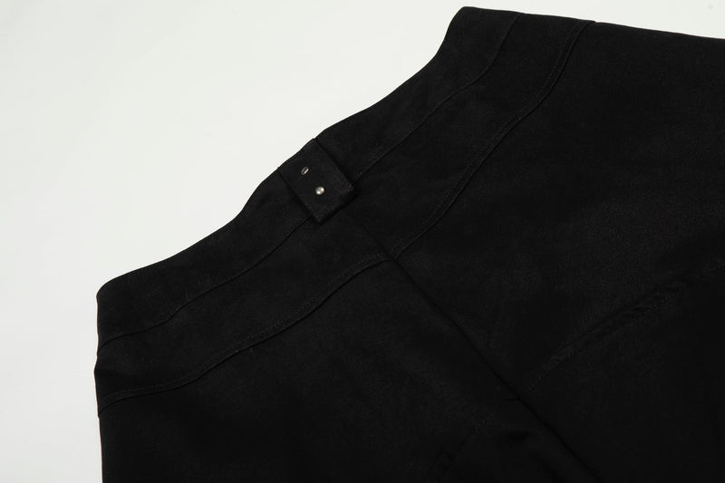 Close-up of black pants waistband seam and belt loop with snap studs