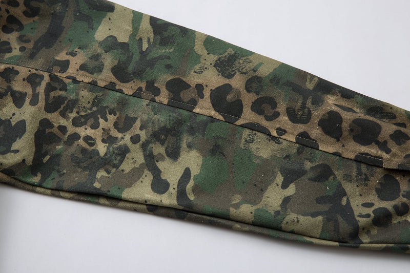 Close-up of shirt hem and side seam on camo leopard overshirt