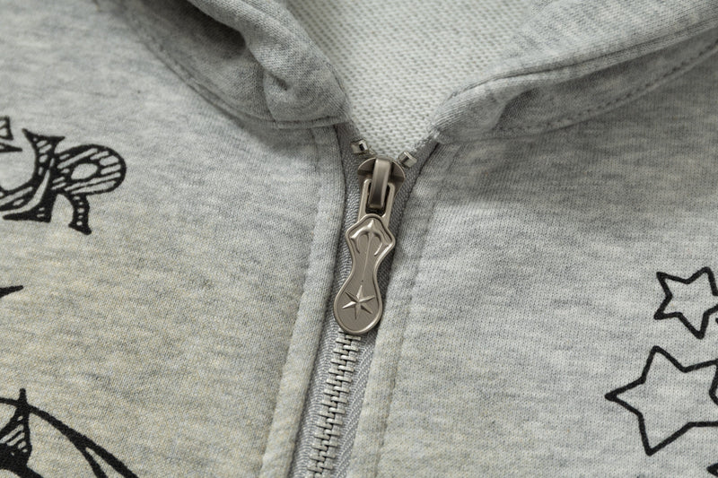 Close-up of metallic zipper pull on grey graphic zip hoodie