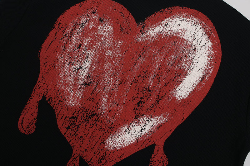 Bold black streetwear tee with a distressed red melting heart graphic and white highlights on the chest