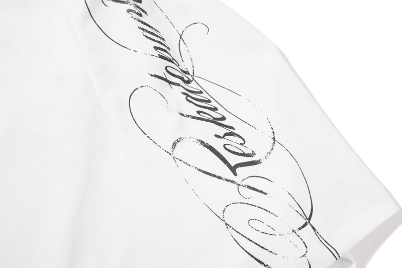 White distressed graphic polo shirt with bold black script print on the chest, shown in a close-up product view