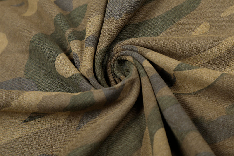 Close-up of soft camouflage fabric gathered in a spiral fold