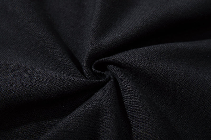 Close-up of black denim fabric texture and seam fold