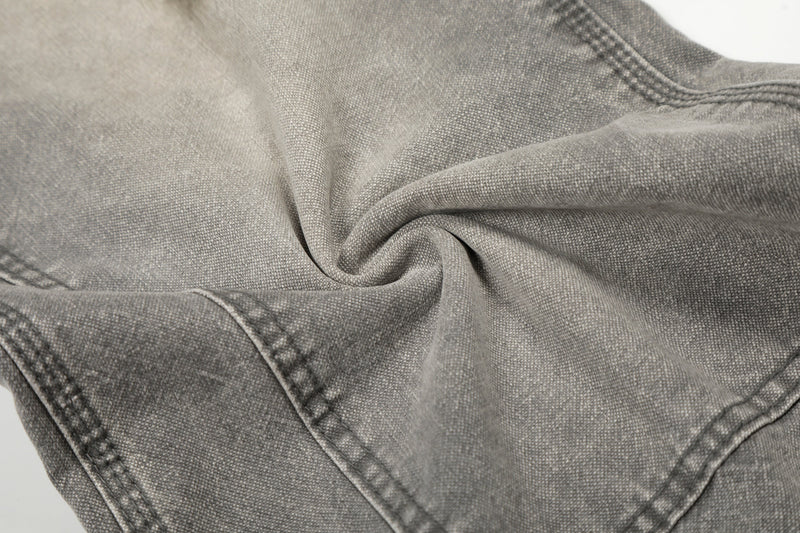 Close-up of gray denim fabric texture and stitched seam details