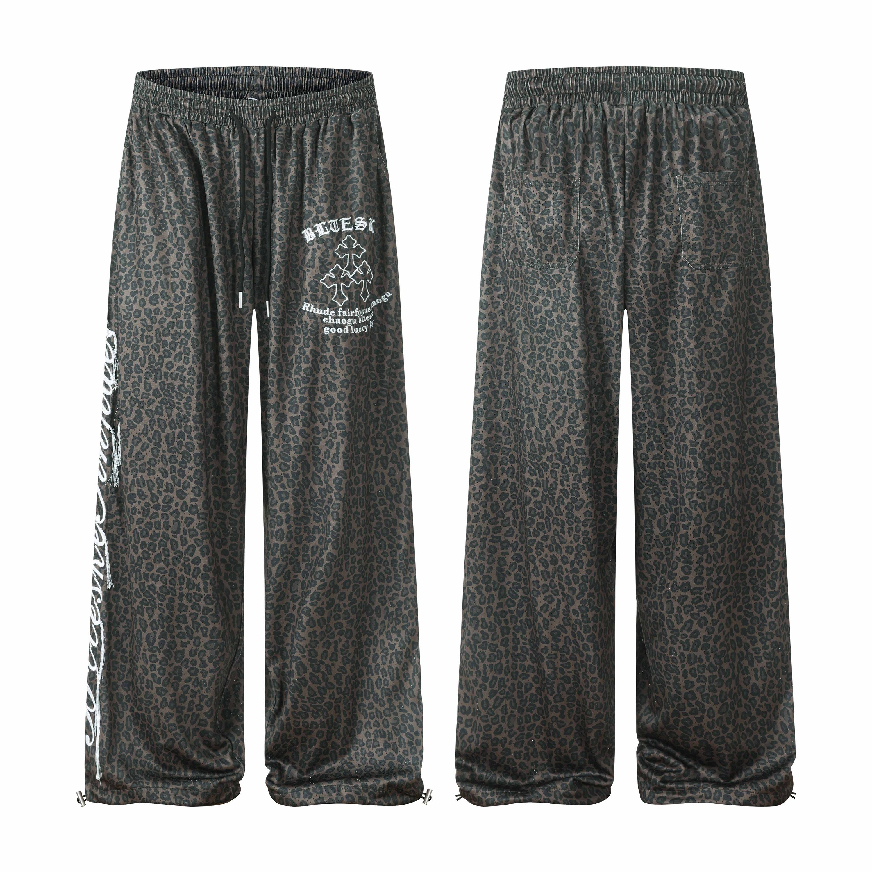 Dark charcoal leopard print wide-leg sweatpants with white gothic graphic print on leg, front and back view