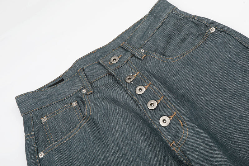 Close-up angled front waistband of washed grey denim jeans with button fly and pocket