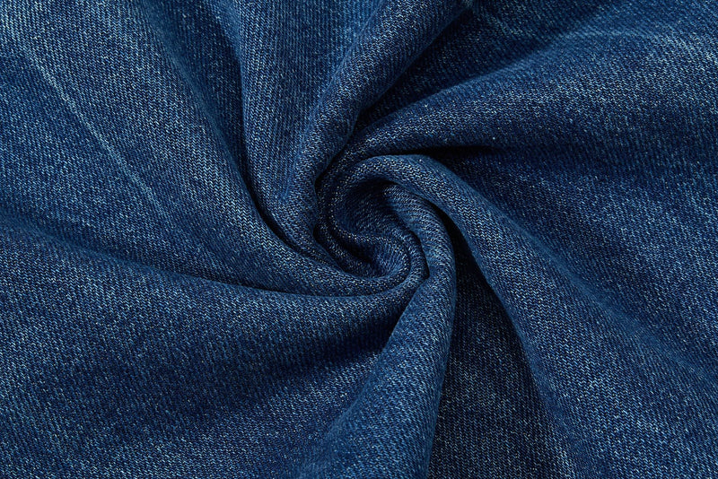 Close-up of blue denim fabric swirl showing texture and weave