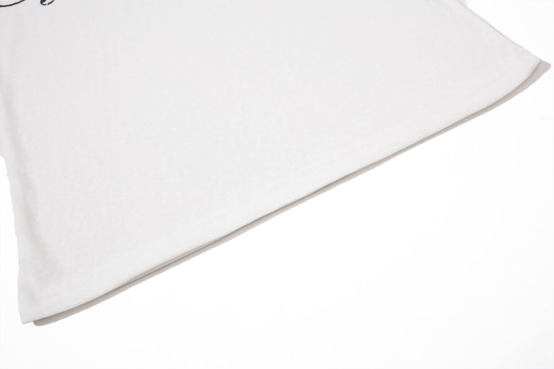 Close-up of a white polo shirt sleeve with clean hem and soft fabric texture