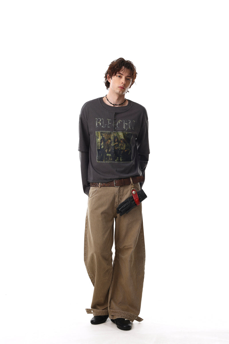 Full-body model view of charcoal layered graphic tee with oversized fit and long sleeves