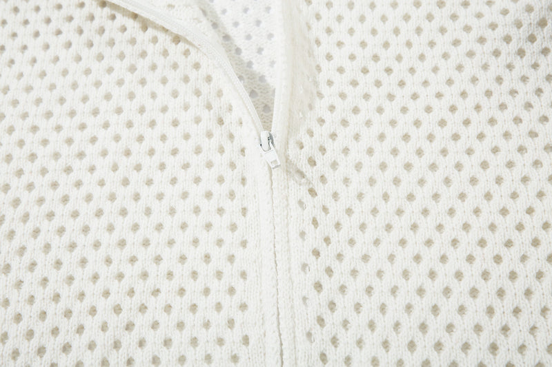 Close-up of white open-knit fabric and center zipper on the jacket front