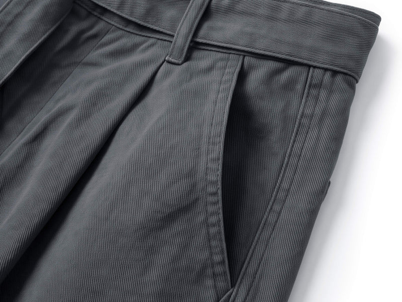 Close-up of charcoal shorts hem with stitched seam and side panel