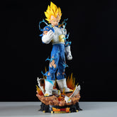 The Seakoff Vegeta Collectible Figure from Dragon Ball Z stands 55cm tall, featuring Super Saiyan with muscular physique and spiky yellow hair in a blue/white outfit. It comes with a detailed base displaying the logo, surrounded by dynamic energy effects, plus 3 interchangeable heads.